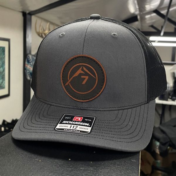 Gray trucker hat with a round Peak 7 leather patch