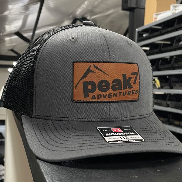 Gray trucker hat with a Peak 7 Adventures leather patch