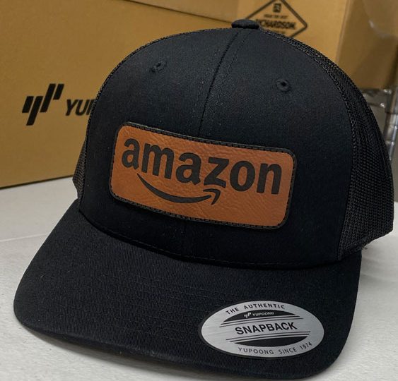 Black trucker hat with an Amazon leather patch