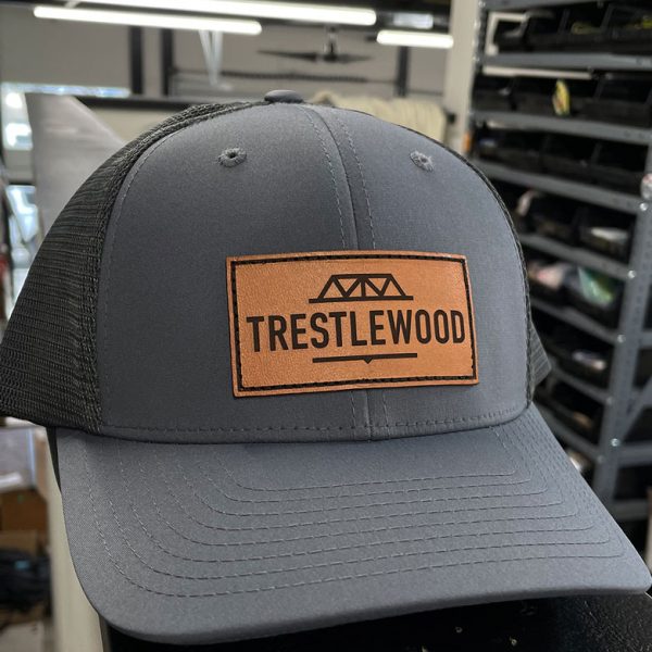 Gray trucker hat with a Trestlewood leather patch